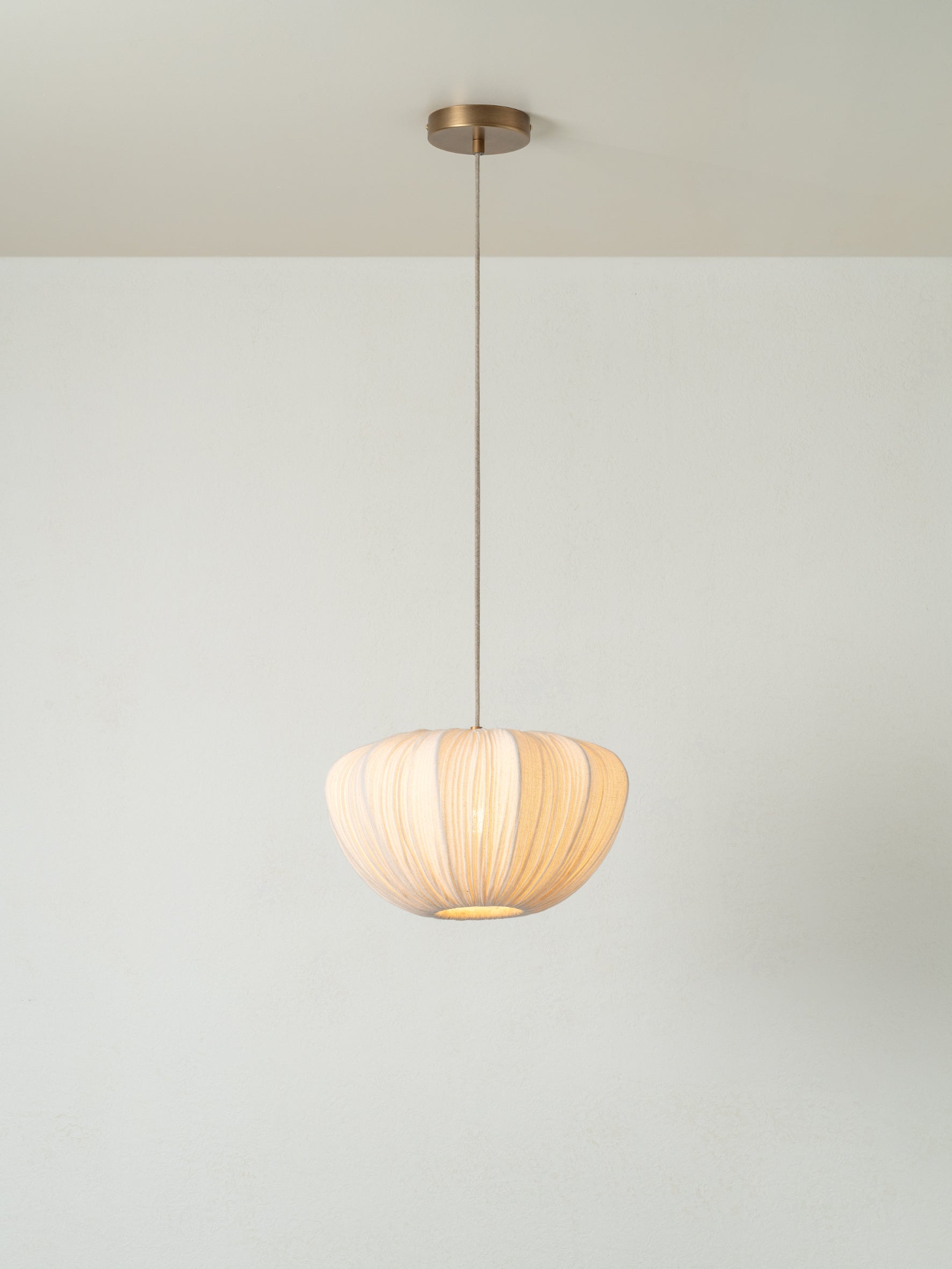 lights&lamps Ostrea pendant light with a pleated linen design on a plain background