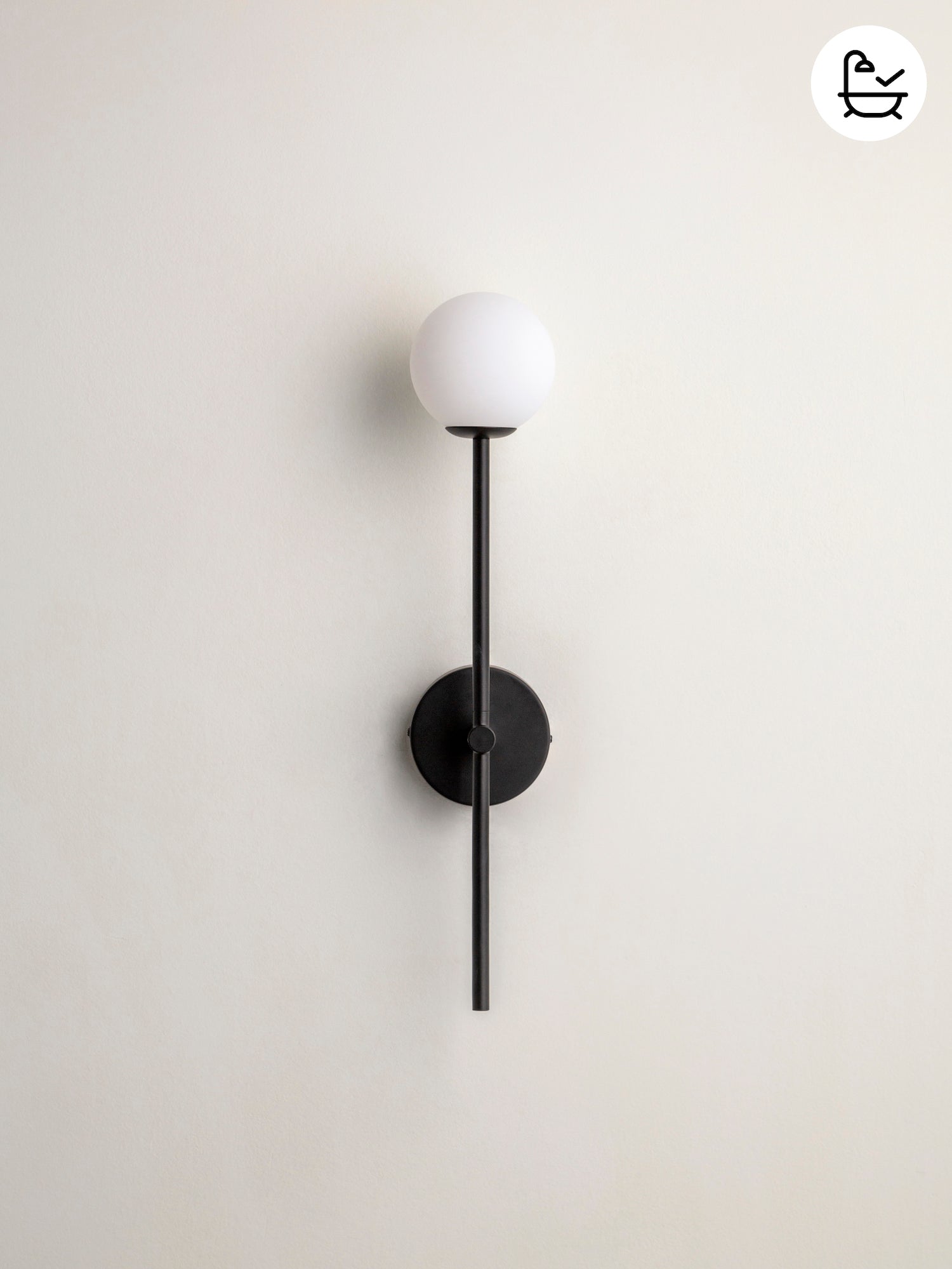 Modern wall lamp with black fixture and white globe on a light gray background