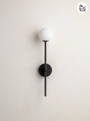 Modern wall lamp with black fixture and white globe on a light gray background