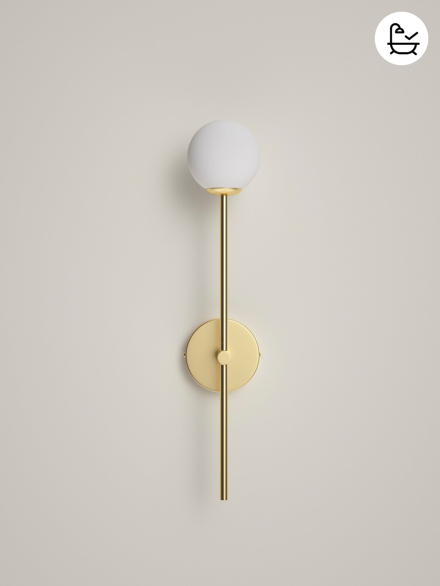 Wall-mounted light fixture with white globe and gold arm on a beige background