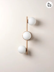 Modern wall light fixture with three spherical bulbs on a beige background