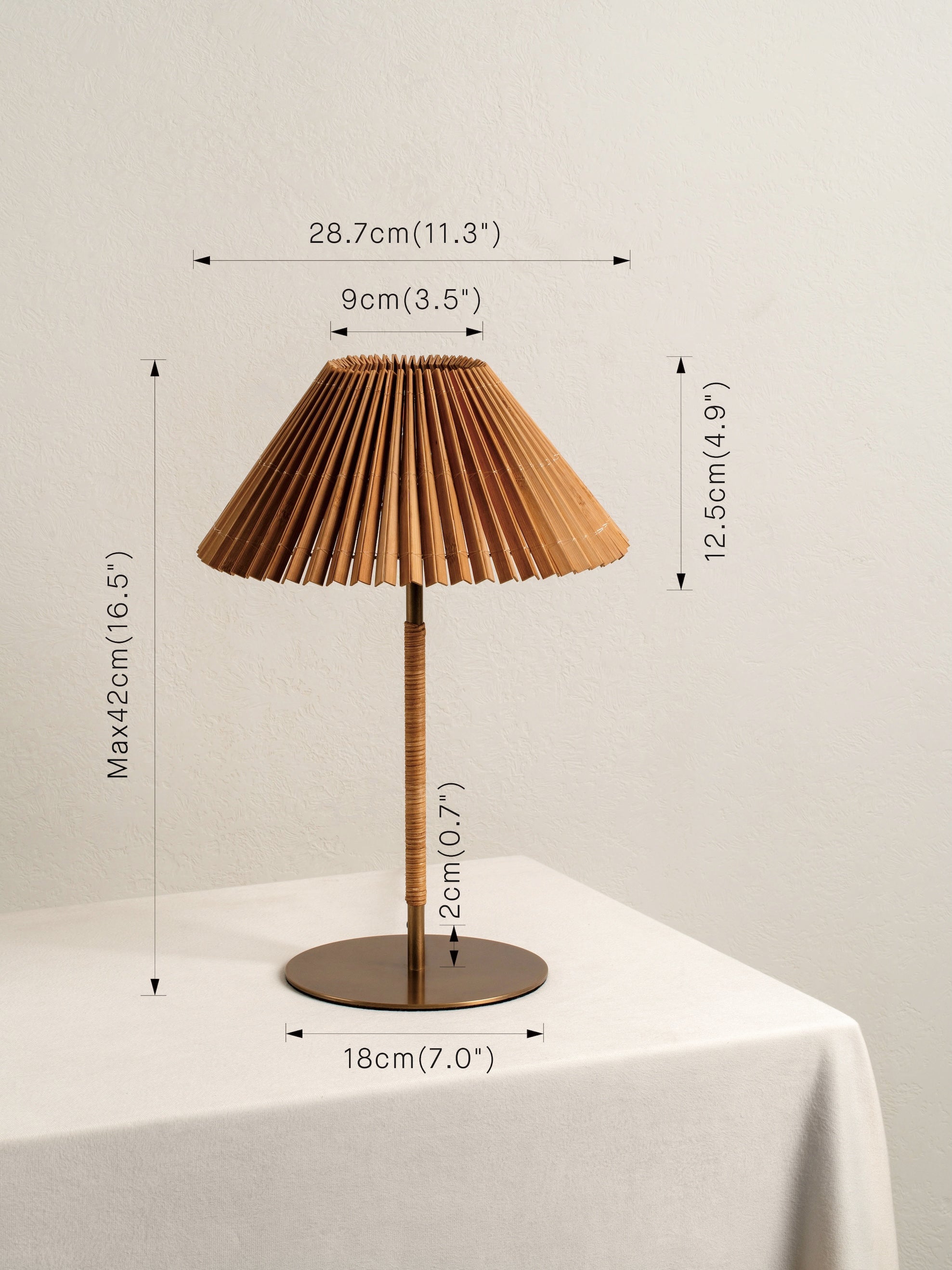 Table lamp with pleated brown shade and dimensions marked on a neutral background
