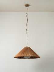 Wooden pendant light hanging against a plain wall