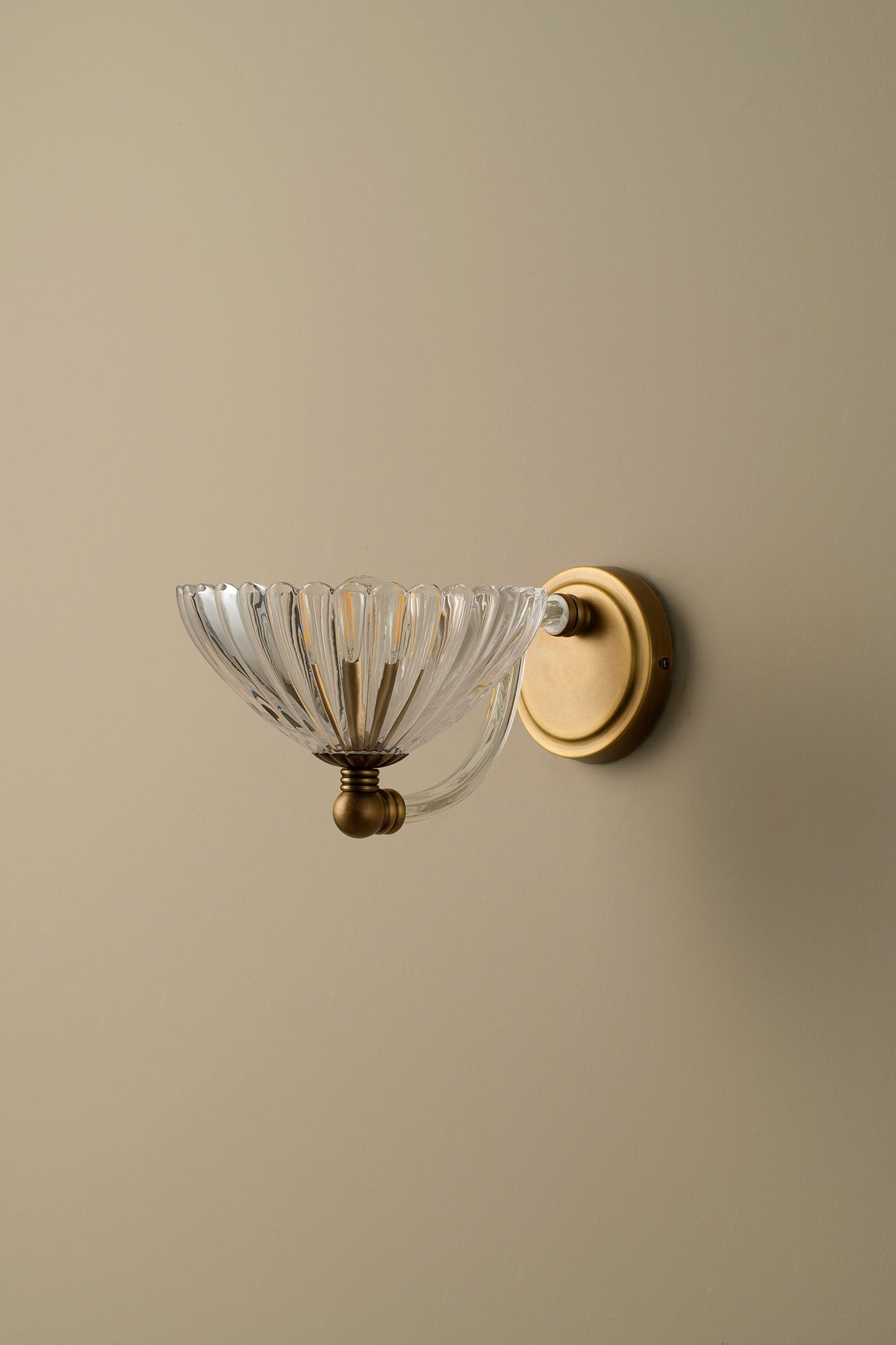 Wall-mounted light fixture with dimensions indicated on a green wall.