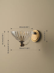 Wall-mounted light fixture with clear glass shade and gold metal finish, shown with dimensions on a beige background.