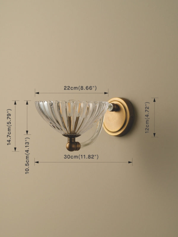 Wall-mounted light fixture with clear glass shade and gold metal finish, shown with dimensions on a beige background.