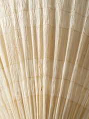 close up of pleated, cone-shaped off-white shade 