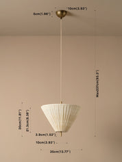 A hanging pendant light with a white pleated conical shade and a brass-toned ceiling mount and cord, shown against a plain beige wall with overlaid dimension labels and measurement lines.