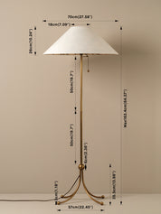 A brass floor lamp with a white tapered conical shade, shown with overlaid dimension lines and measurements on a plain beige background.