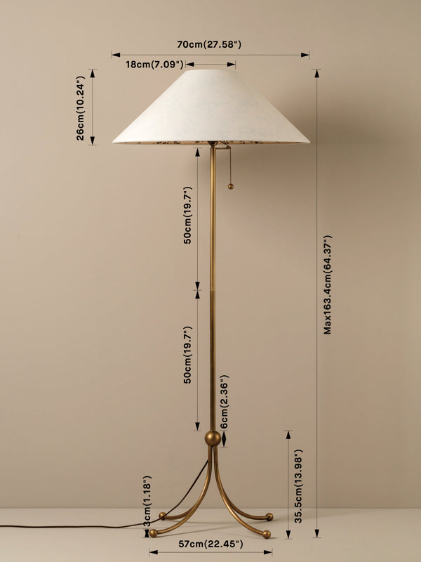A brass floor lamp with a white tapered conical shade, shown with overlaid dimension lines and measurements on a plain beige background.