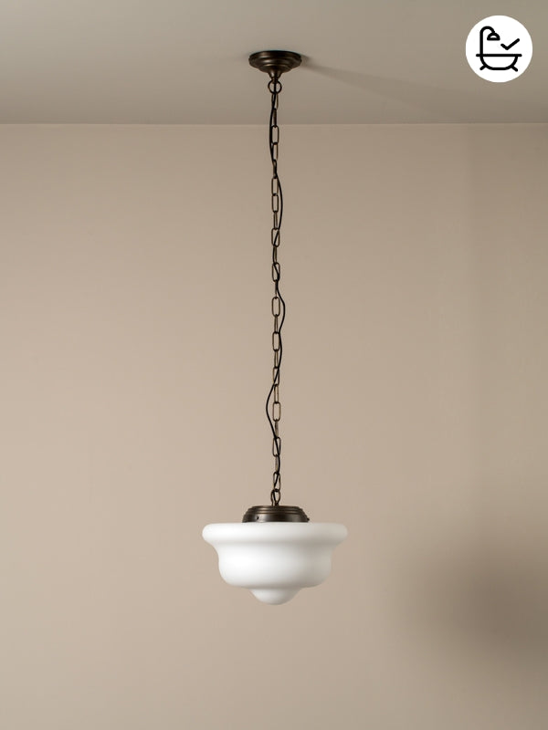 Vintage-style pendant light with white glass shade and black metal chain against a beige wall.