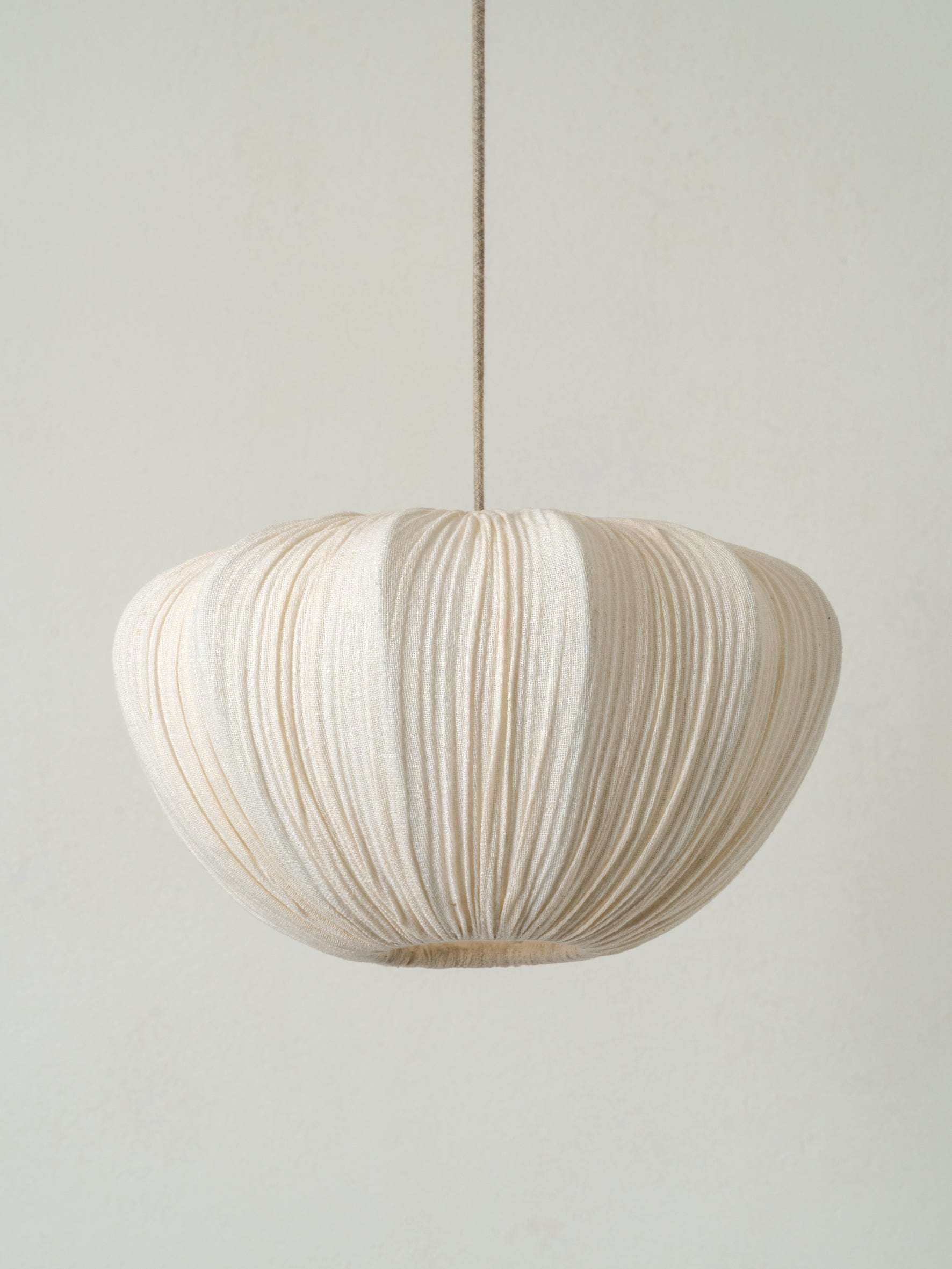 lights&lamps Ostrea pendant light with a pleated linen design on a plain background